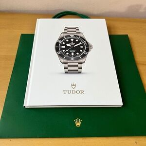 TUDOR 2025-2026 HARDCOVER WATCH COLLECTION CATALOG BOOK ENGL ROLEX SHOPPING BAG